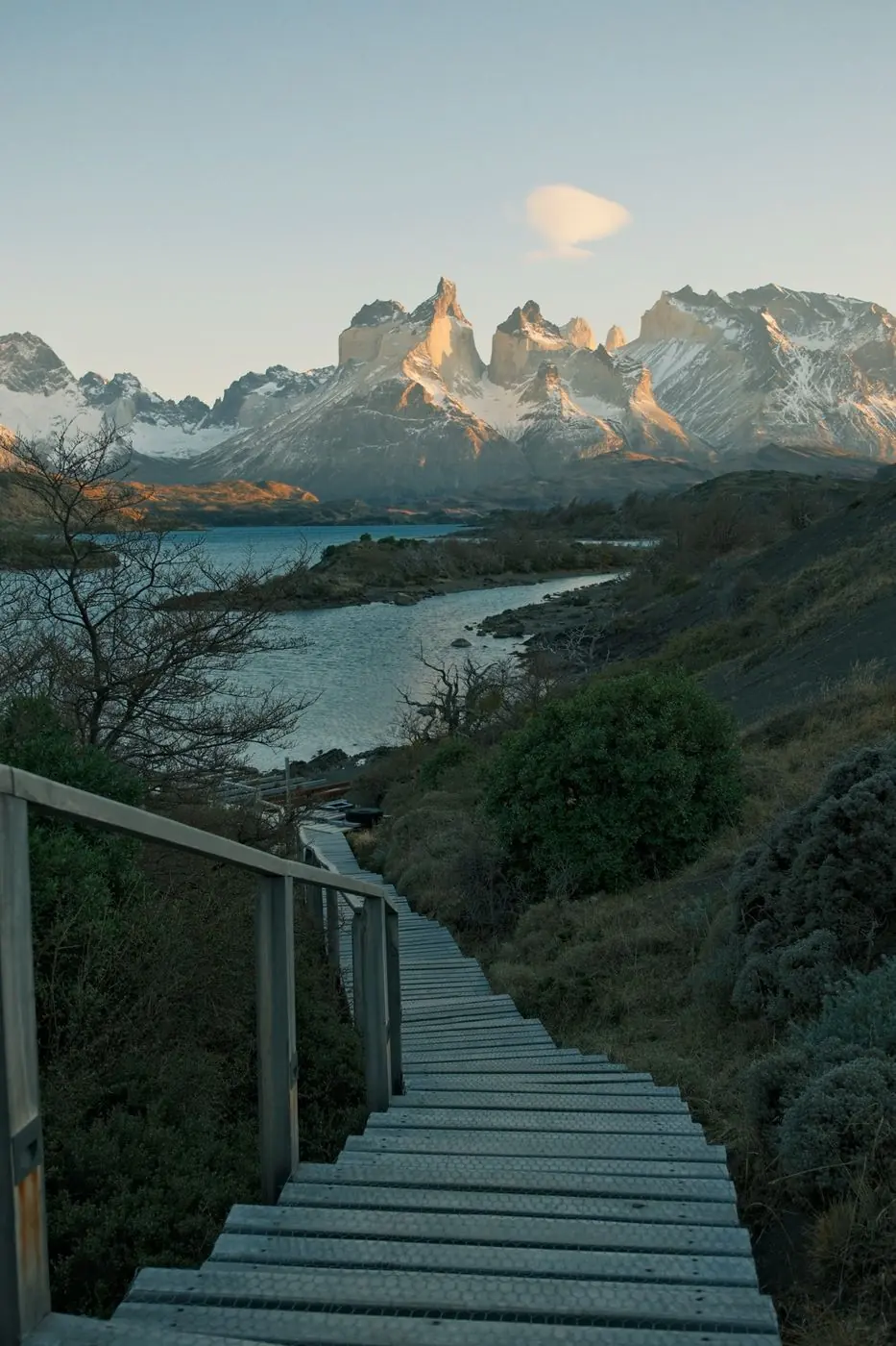 A wooden stairway down to Lago Pehoé at first light, the Cuernos glowing beyond