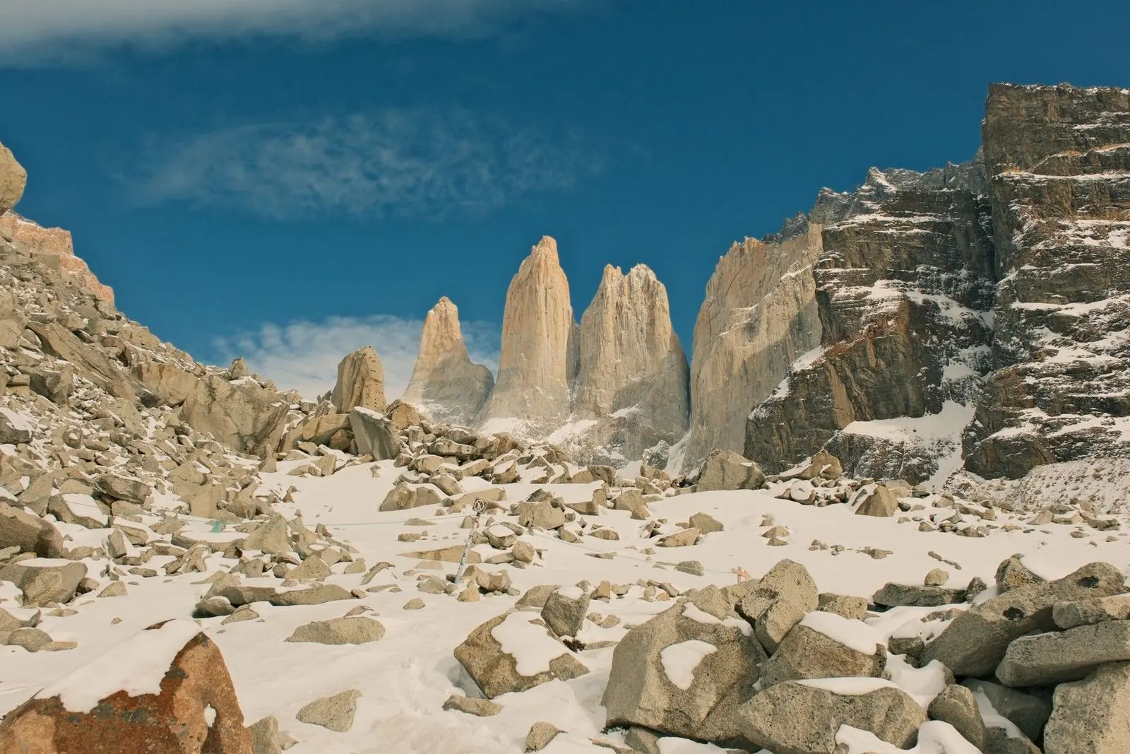 The three granite towers of Torres del Paine above a snow-covered boulder field