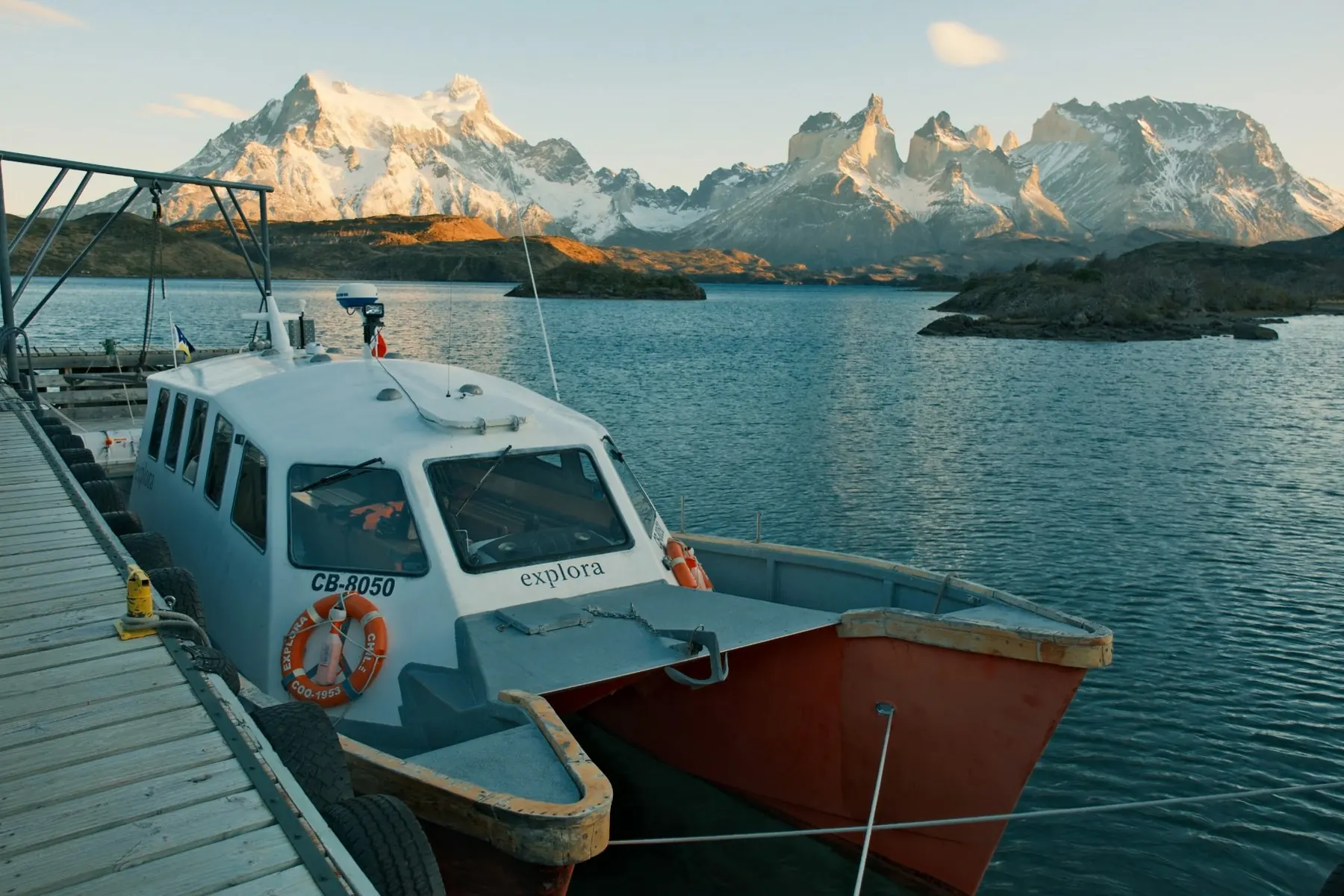 Explora’s boat moored at the dock on Lago Pehoé, Paine Grande and the Cuernos behind