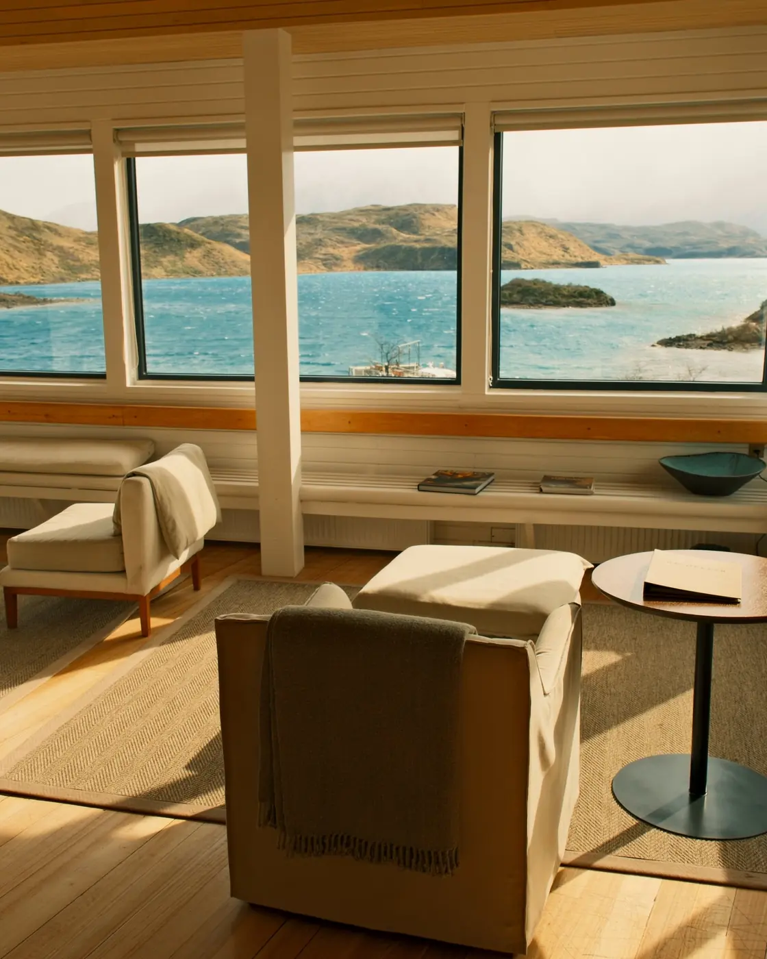 Tea for three on a sunlit table, Lago Pehoé and the hotel dock through the window