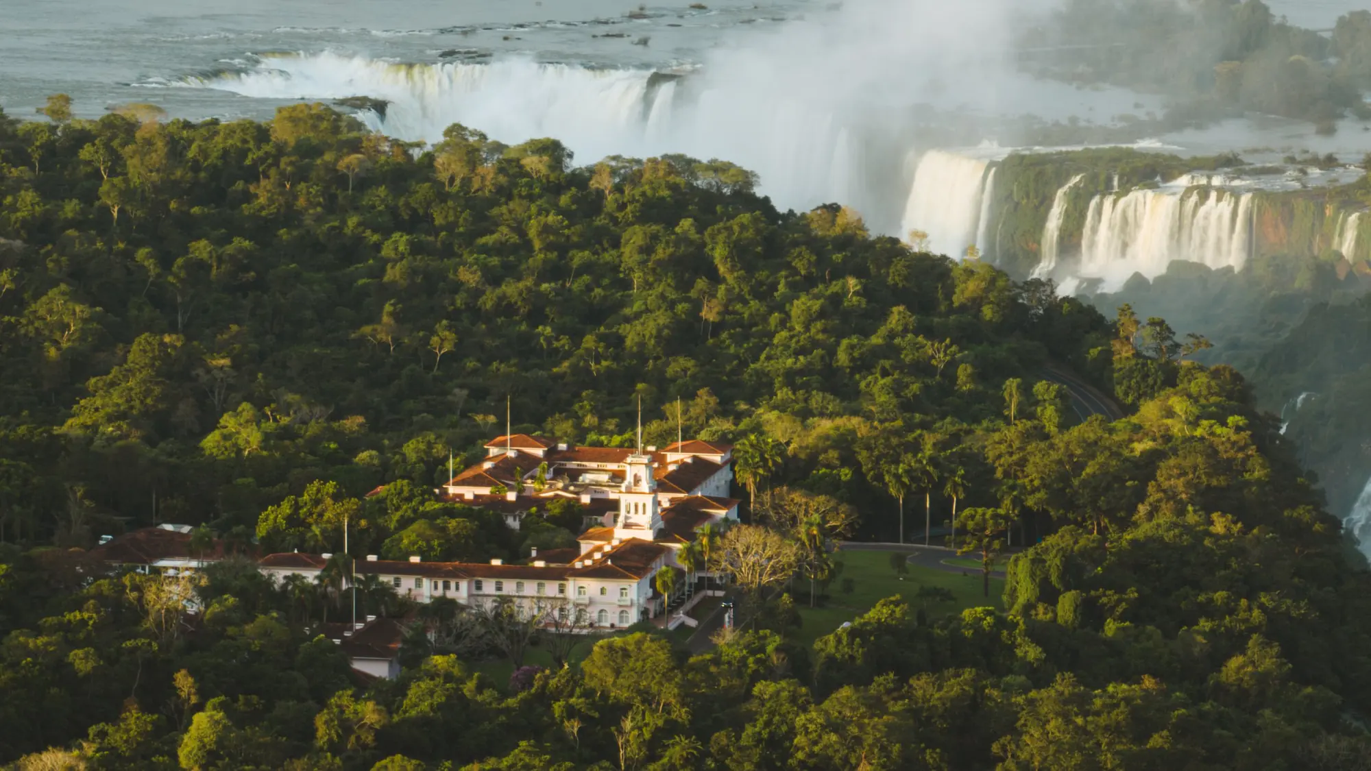 A rainbow over the Devil’s Throat at Iguazu Falls under storm clouds