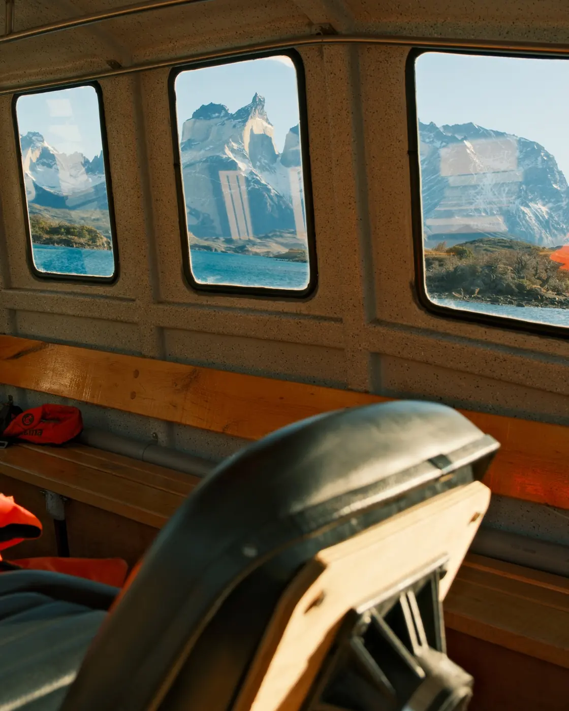Explora’s red-hulled boat moored on Lago Pehoé, the Cuernos del Paine beyond